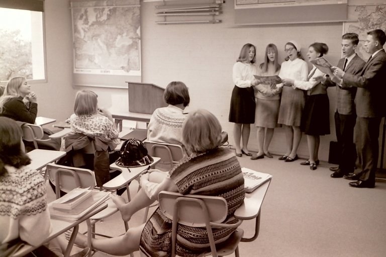 Carolers sing in a classroom