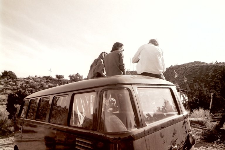 Students sit on a Volkswagen bus during a trip to the Mojave Desert