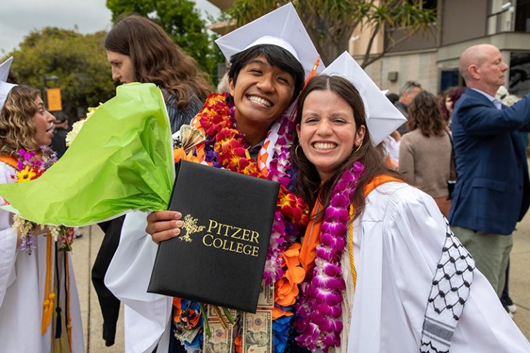A Pitzer student shows off his diploma at Commencement