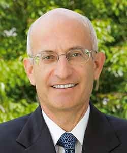 headshot of don gould with greenery behind him
