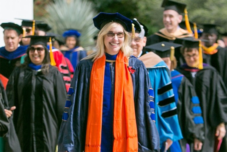 Melinda Herrold-Menzies walks during commencement