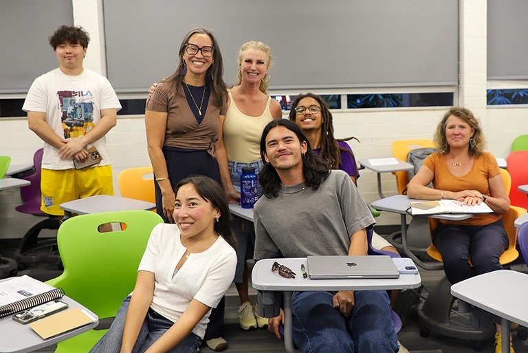 Barbara Junisbai poses with students and parents after her lecture at Pitzer's Family Weekend 2025