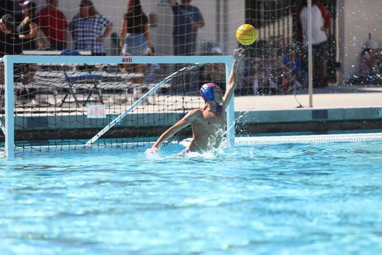 greg moore blocks a goal during a water polo game
