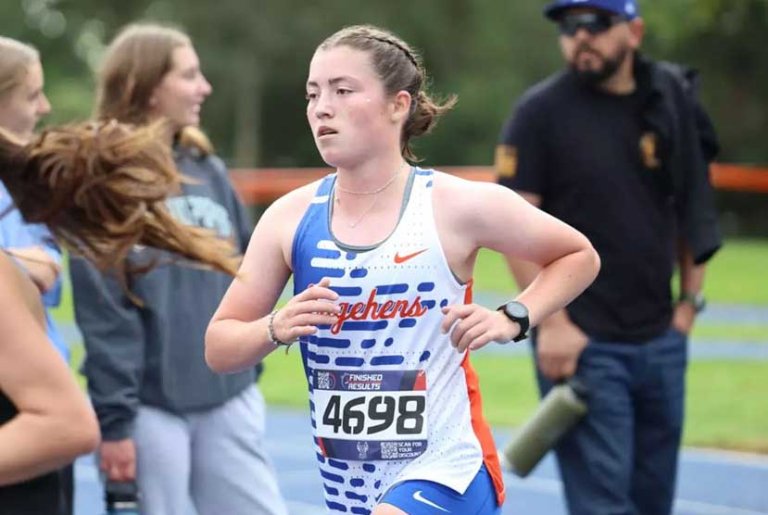 Kate Sherry runs past spectators during a race