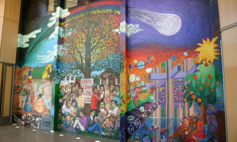 a mural showing scenes of Pitzer's past, present, and future