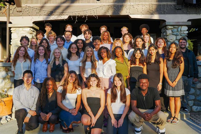Student senate members pose on the steps of the grove house. 