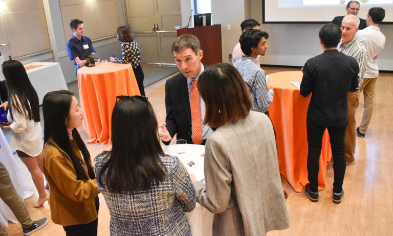 students mingle at a networking event