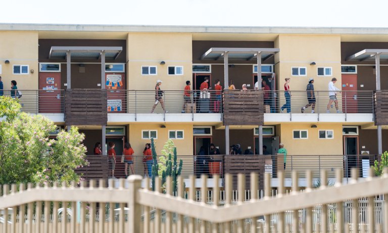 students and parents walk on the pitzer dorm outside walkways while moving into the dorms