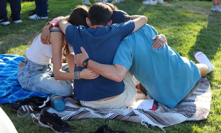 a family group hugs on the mounds