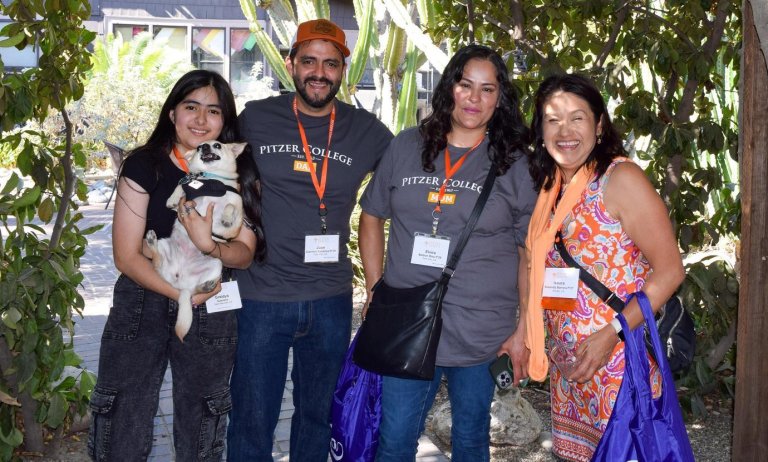 a family poses under the outdoor classroom pergola