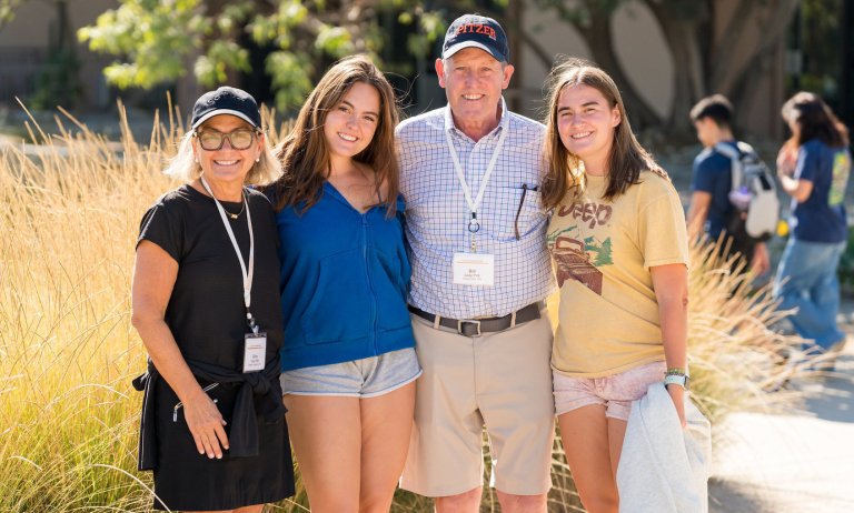 a family poses on Pitzer's campus