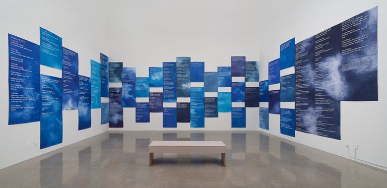 Blue-and-white text-based artwork by Andrea Bowers