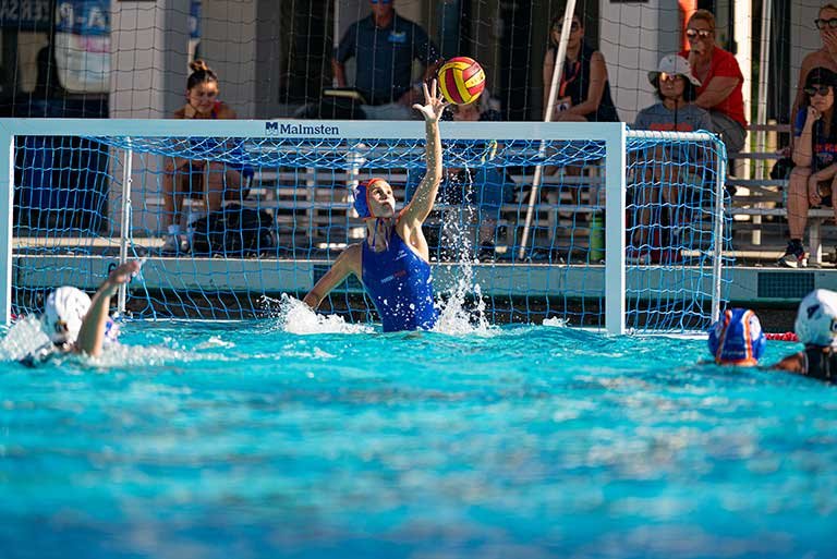 Isabella Dova blocks a goal during a water polo game
