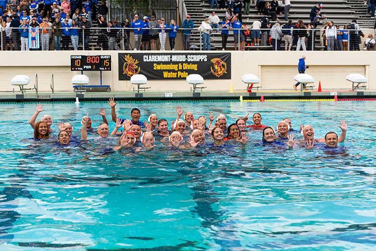 2026 women's water polo team pose in a pool