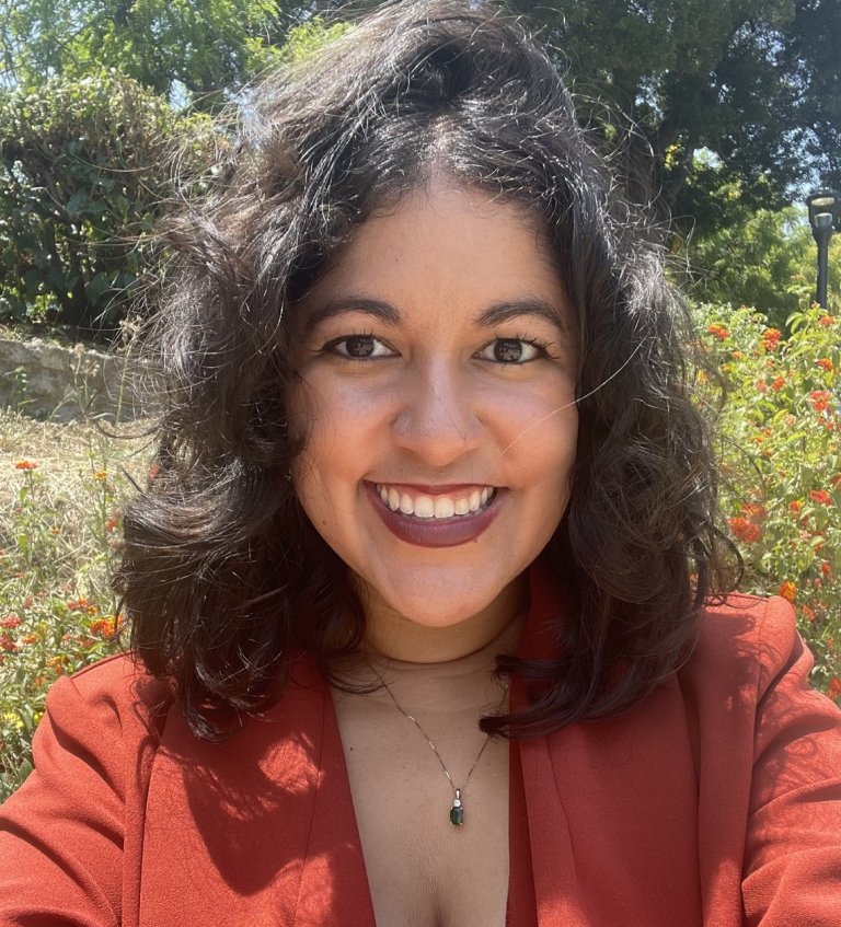 Andrea Acosta with plants in the background