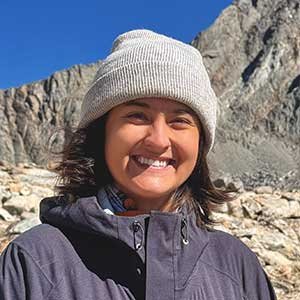 Sasha Lu with rocky mountains in the background