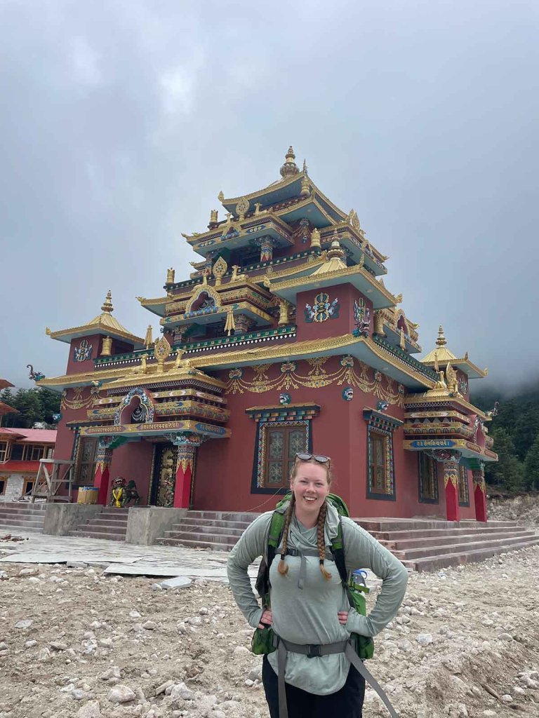 Madison Wilson poses in front of a temple