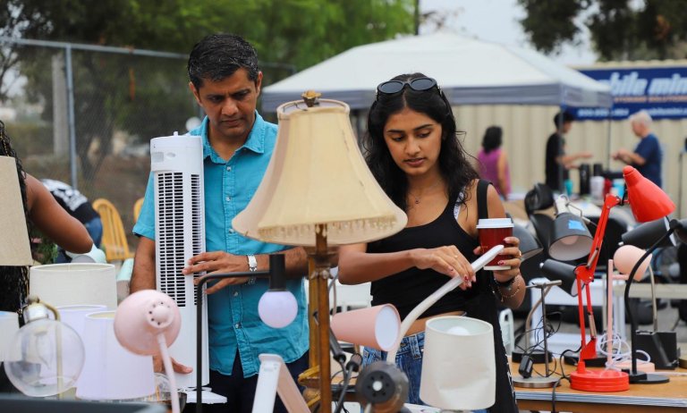 a student and their father browse lamps at the Pitzer ReRoom sale
