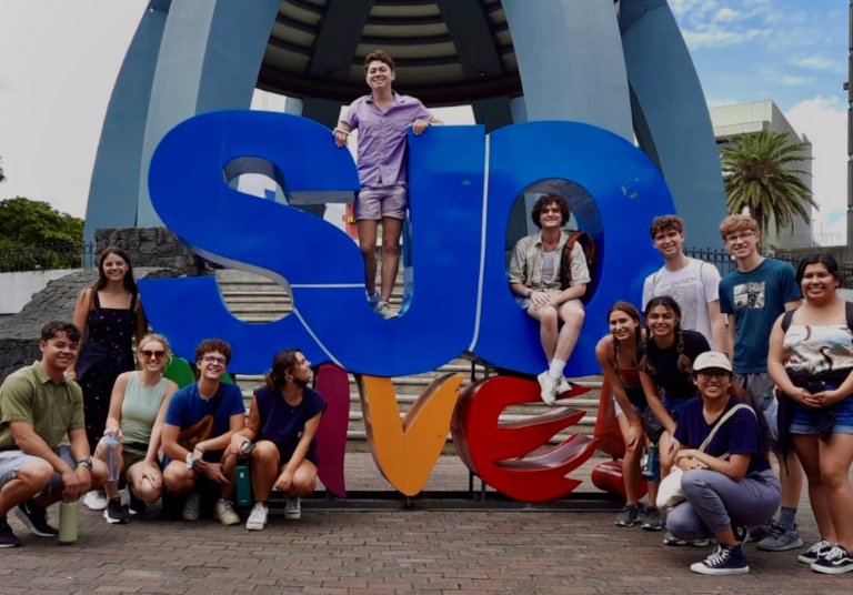 Group in front of SUD LOVE sign