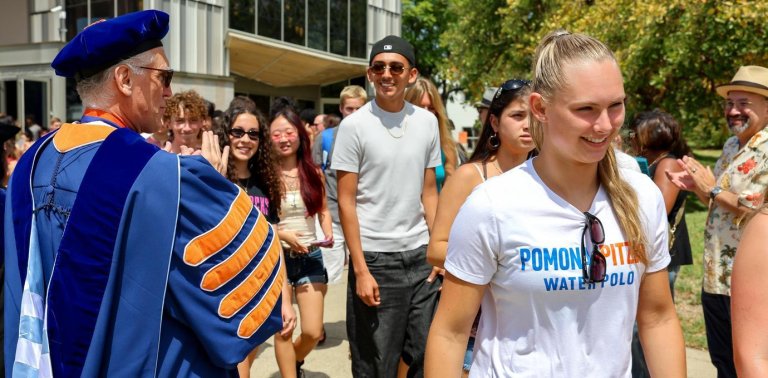 students walking out in a line with faculty around them