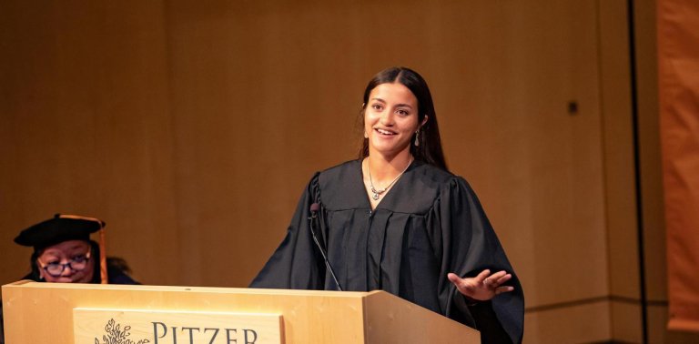 student senate president, Amirah Haque, speaking at the podium