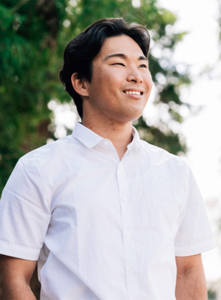 Matthew Nishimura smiles, looking off to the distance