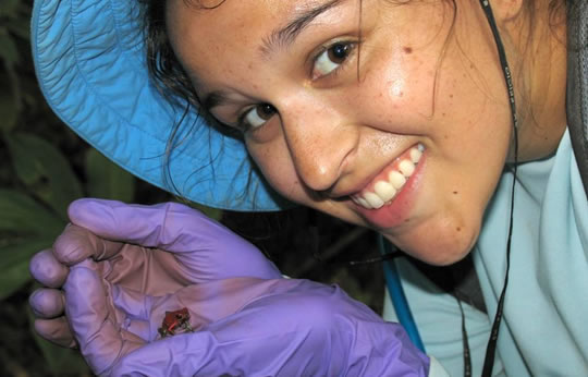Student with a small red frog in Costa Rica