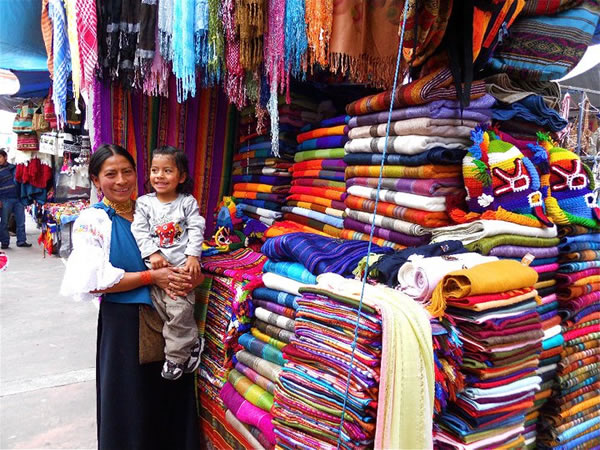 Colorful woven blankets in Ecuadorian street market