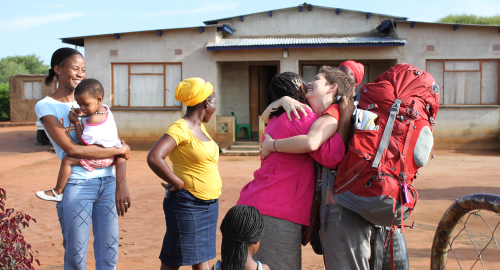 Pitzer student gets a hug from her Botswana host family.